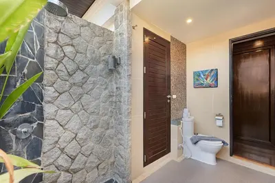 a bathroom with a toilet and a walk in shower at Secret Balinese Escape villla Eva in Rawai Beach
