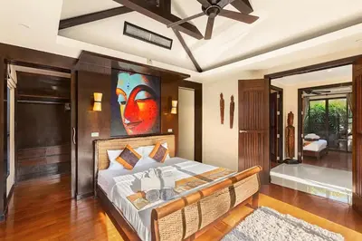 a bedroom with a bed with a painting on the wall at Secret Balinese Escape villla Eva in Rawai Beach