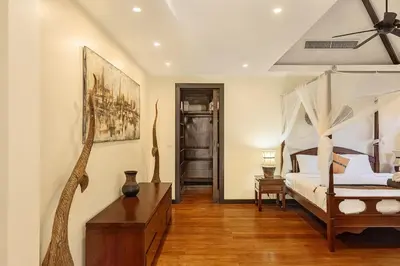 a bedroom with a bed and a dresser in it at Secret Balinese Escape villla Eva in Rawai Beach