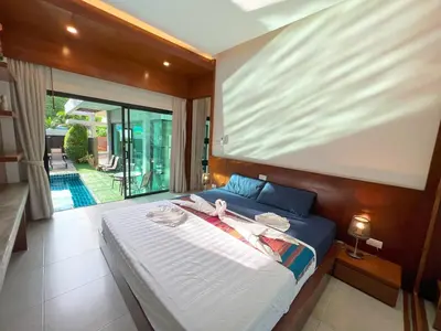 a bedroom with a large bed and a balcony at Intimate Oasis, 2 bedrooms Pool in Kata Beach