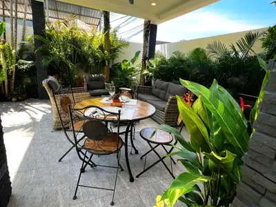 a patio with a table and chairs and plants at Intimate Oasis, 2 bedrooms Pool in Kata Beach