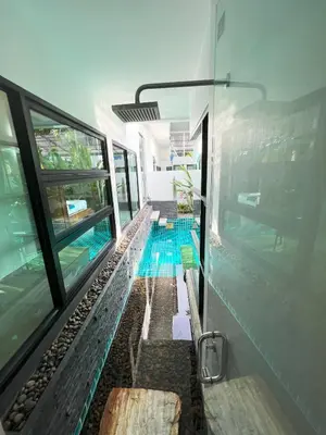 a swimming pool in the middle of a building at Intimate Oasis, 2 bedrooms Pool in Kata Beach