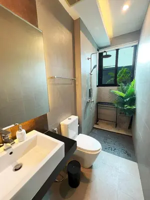a bathroom with a sink and a toilet and a window at Intimate Oasis, 2 bedrooms Pool in Kata Beach