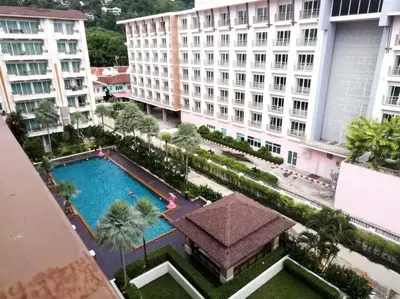 an overhead view of a pool in a city with buildings at Quiet Patong Apartment near Night Life & Good Food in Patong Beach