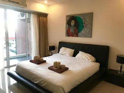 a bedroom with a bed with two towels on it at Апартаменты с видом на море на Карон Бич А 409 in Karon Beach