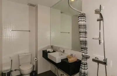 a bathroom with a sink and a toilet and a mirror at Апартаменты с видом на море на Карон Бич А 409 in Karon Beach
