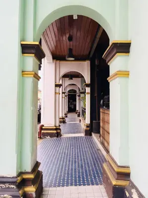 an empty hallway of a building with a wooden ceiling at Phuket Sunny Hostel in Phuket Town