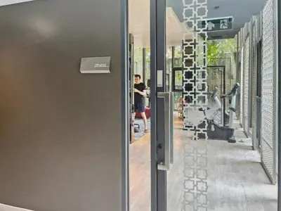 a hallway of a gym with a person in the background at The Base - New Studio Great location, shared Pool in Ban Rangeng