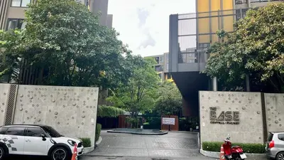 a white car parked in a parking lot with a less sign at The Base - New Studio Great location, shared Pool in Ban Rangeng