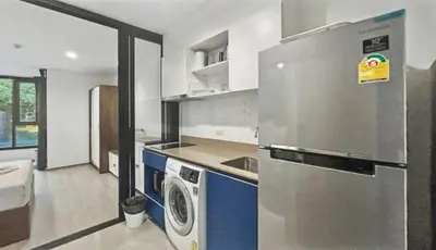 a kitchen with a refrigerator and a washing machine at The Base - New Studio Great location, shared Pool in Ban Rangeng