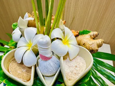 a group of white flowers sitting on top of a table at The Yama Hotel Phuket in Kata Beach
