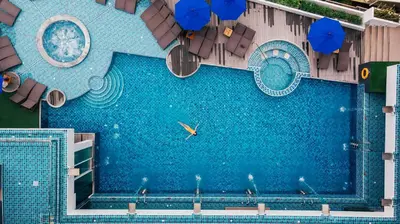 an overhead view of a swimming pool with umbrellas at The Yama Hotel Phuket in Kata Beach