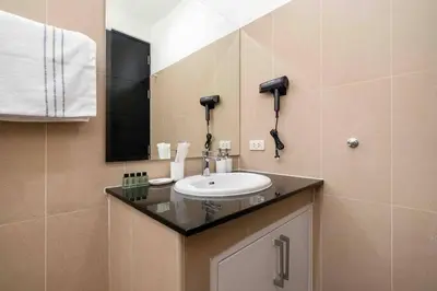 a bathroom with a sink and a mirror at Brand New 3 Bedroom Pool Villa in Ban Saiyuan (1)