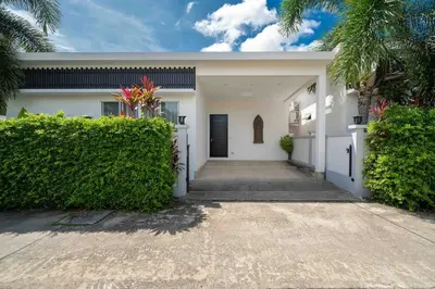 a white house with a gate and a driveway at Brand New 3 Bedroom Pool Villa in Ban Saiyuan (1)