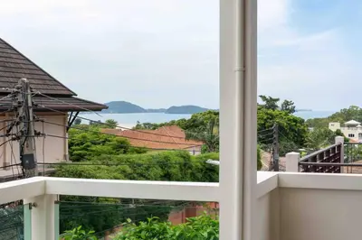 a view of the water from a balcony at 1 bedroom apartment in Nai Harn in Ban Saiyuan (1)