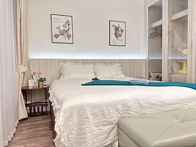 a bedroom with a large white bed in it at OCEANA HOME Phuket Kamala in Kamala Beach