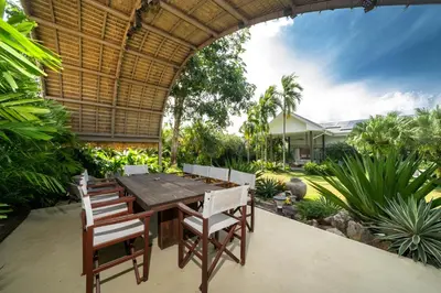an outdoor dining room with a table and chairs at Contemporary Eden - Villa Jeladore, 5BR, Garden & Pool, near Laguna in Bang Tao Beach