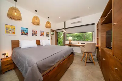 a bedroom with a bed and a desk and a window at Contemporary Eden - Villa Jeladore, 5BR, Garden & Pool, near Laguna in Bang Tao Beach