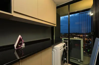 a kitchen with a washing machine and a window at 3bdr Sea View Apartment Surin Beach by Capital Pro in Phuket Town
