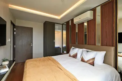 a bedroom with a large bed with white sheets at 3bdr Sea View Apartment Surin Beach by Capital Pro in Phuket Town