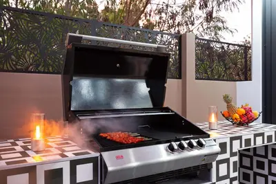 a barbecue grill on a patio with flames at Brand-new 8BR Private Pool Villa Mystic Garden in Rawai Beach