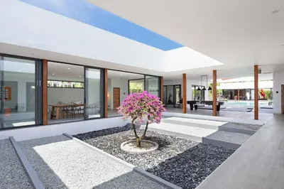 a house with a tree in the middle of a courtyard at Brand-new 8BR Private Pool Villa Mystic Garden in Rawai Beach