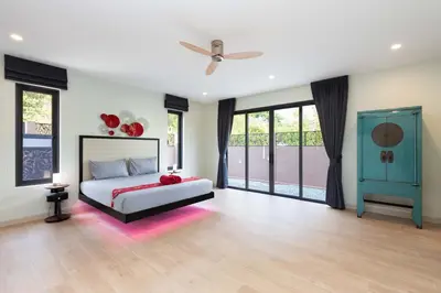 a bedroom with a bed and a ceiling fan at Brand-new 8BR Private Pool Villa Mystic Garden in Rawai Beach