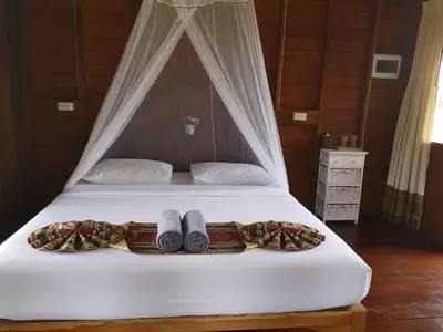 a white bed with two blankets and two towels on it at NammNatawn2 in Ko Yao Noi