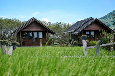 a house with a fence in front of a field at NammNatawn2 in Ko Yao Noi