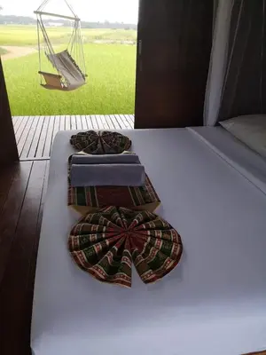 two ties on a bed in a tent with a swing at NammNatawn2 in Ko Yao Noi