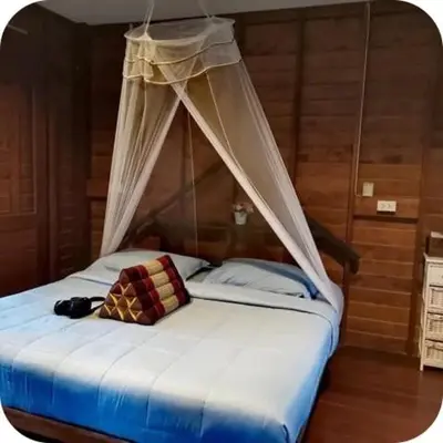 a bed with a canopy in a room at NammNatawn2 in Ko Yao Noi