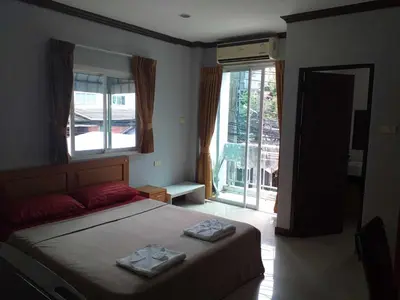 a bedroom with a bed with two towels on it at Elba Bella Guest House in Patong Beach