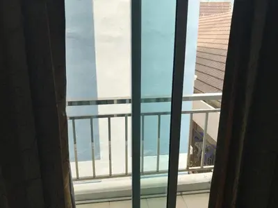 an open window with a view of a building at Elba Bella Guest House in Patong Beach