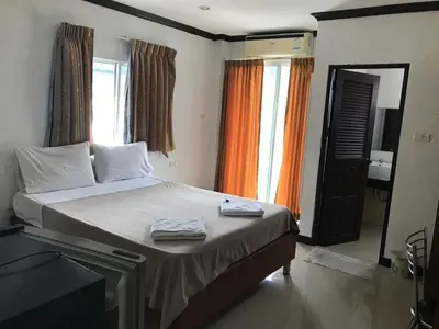 a bedroom with a bed with two towels on it at Elba Bella Guest House in Patong Beach