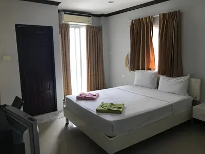 a bedroom with a bed with two towels on it at Elba Bella Guest House in Patong Beach