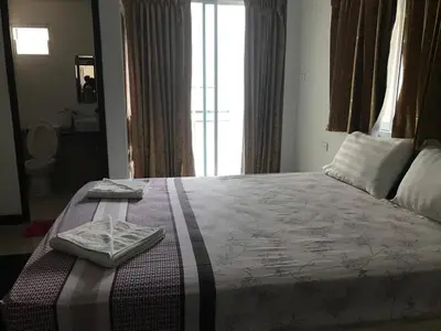 a bedroom with a bed with two towels on it at Elba Bella Guest House in Patong Beach