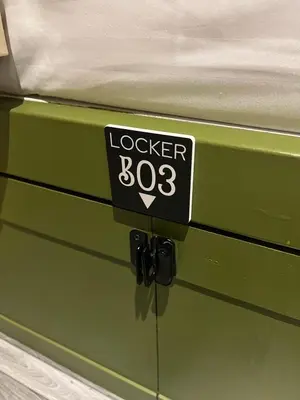 a green drawer with a sign that reads locker at Sierra Hostel in Nai Yang Beach