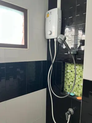 a shower in a bathroom with a blow dryer at Nacha Hostel, Koh Phi Phi, Krabi. THAILAND in Phi Phi Don