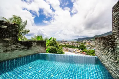 a swimming pool with a view of a city at \u82ad\u4e1cVilla2:\u56db\u5367\u6d77\u666f\u522b\u5885 \u53cc\u6d77\u666f \u4e2d\u82f1\u6cf0\u4e09\u6587\u7ba1\u5bb6 in Patong Beach