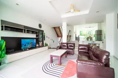 a living room with leather furniture and a flat screen tv at \u82ad\u4e1cVilla2:\u56db\u5367\u6d77\u666f\u522b\u5885 \u53cc\u6d77\u666f \u4e2d\u82f1\u6cf0\u4e09\u6587\u7ba1\u5bb6 in Patong Beach
