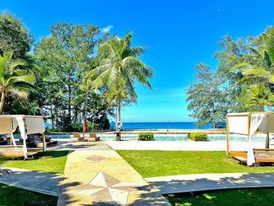 a resort with a view of the ocean at Estella Phuket Mai Khao Beach Resort in Mai Khao Beach