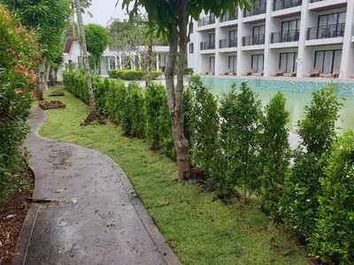 a path in front of a building with a fence at Estella Phuket Mai Khao Beach Resort in Mai Khao Beach