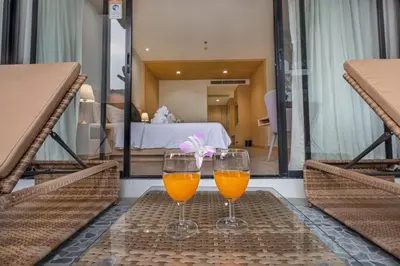 two glasses of orange juice sitting on a table at Estella Phuket Mai Khao Beach Resort in Mai Khao Beach