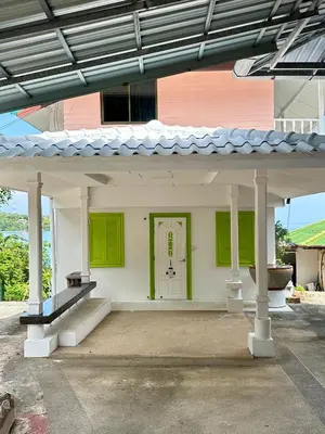 a house with a white and green front door at Mr Oh's Seaview House Phuket AoYon in Phuket Town