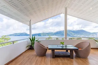 a dining room with a view of the water at Patong Blue House Panorama View in Patong Beach