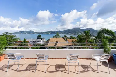 a balcony with chairs and a view of the water at Patong Blue House Panorama View in Patong Beach