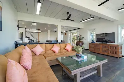 a living room with a couch and a table at Patong Blue House Panorama View in Patong Beach