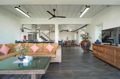 a living room with a couch and a table at Patong Blue House Panorama View in Patong Beach