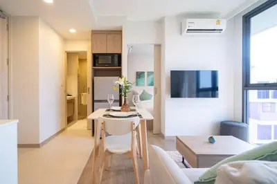a kitchen and living room with a table and a living room at SkyPark , Bangtao , Apartment near beach 2 bedroom in Bang Tao Beach