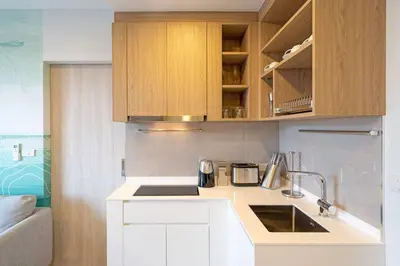 a kitchen with a sink and wooden cabinets at SkyPark , Bangtao , Apartment near beach 2 bedroom in Bang Tao Beach
